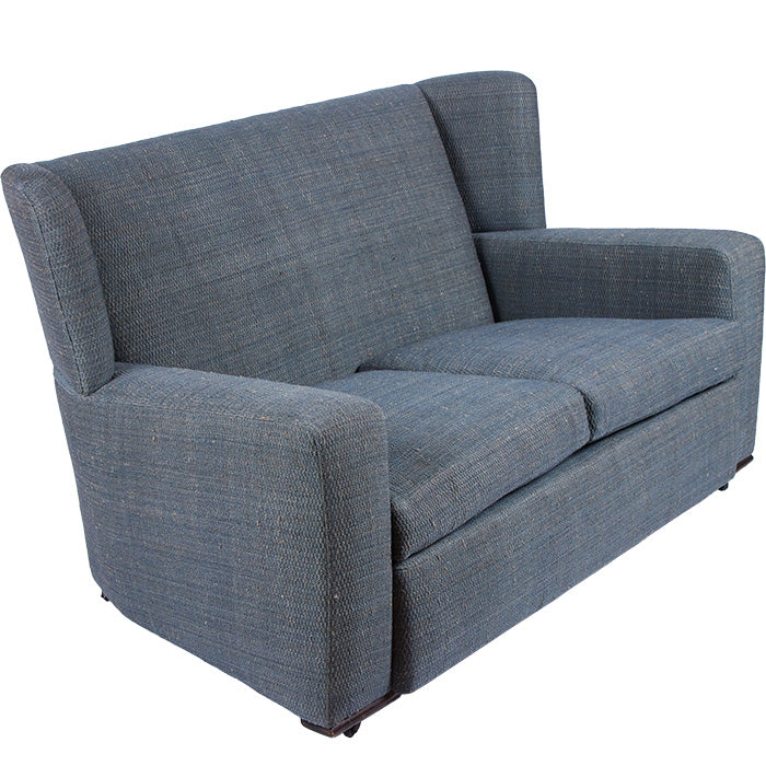 (SIDE VIEW) Art Deco Love Seat with French upholstery fabric in Eye Blue. 1930s design on wooden wheels.