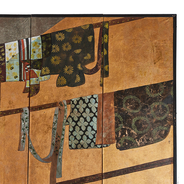 (CORNER) Japanese Screen. Early 20th C Japanese folding screen. Gold and silver leaf background with images of kimonos and obis hanging on traditional wooden racks. Age appropriate wear to surfaces as shown. Folds to small size and backed with Japanese printed paper. Extended size: 37" H x 80" W