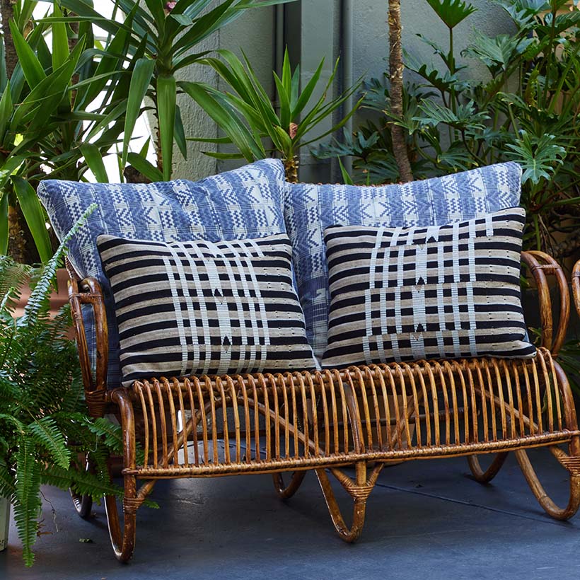 4 Pillows on Rattan Chair on Patio