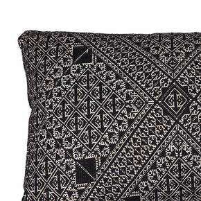 (FABRIC CORNER DETAIL) Fez Embroidery Pillow in black, made from antique Moroccan textiles from the city of Fez. Features intricate black silk floss on linen embroidery, producing a durable fabric with designs based on centuries-old Mehindi (henna hand tattoo) designs. Natural linen back, invisible zipper closure, and feather and down fill. Measures 15" x 43".