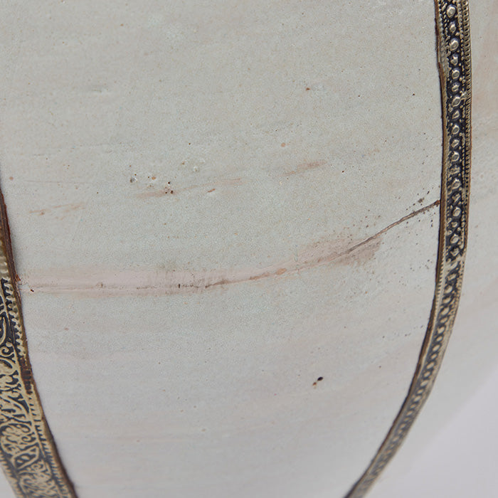 (DETAIL OF CRACKS) Large Moroccan Storage Vessel. 18" high terra cotta urn with white glaze and Moorish metal filigree strips. Some cracks in glaze as shown. 18" H x 19" D