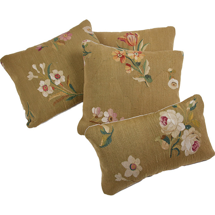 (PILLOW GROUP) Antique Tapestry Pillow V. 18th C. European tapestry fragment pillow. Assorted European blossoms on muddy gold. Natural linen back, invisible zipper closure, feather and down fill. 14" x 16"