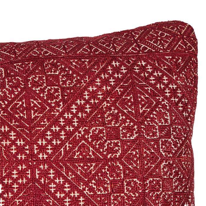 (DETAIL) Bolster pillow made from antique Moroccan textile from the city of Fez. Intricate all-over silk floss on linen embroidery produces a durable fabric. The design is based on centuries old Mehindi (henna hand tattoo) designs. Natural linen back, invisible zipper closure, feather and down fill. 13" x 42"