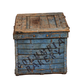 (SIDE VIEW) Vintage Bread Delivery Crate - Well preserved, clean, worn, and used old wooden box with original blue paint visible rust and ageing stamped with block letters in dark blue "Columbia Bakery Colo. Springs Col." Rope handles. Lid opens on hinges to clean wood inside. 17" H x 27" W x 20" D